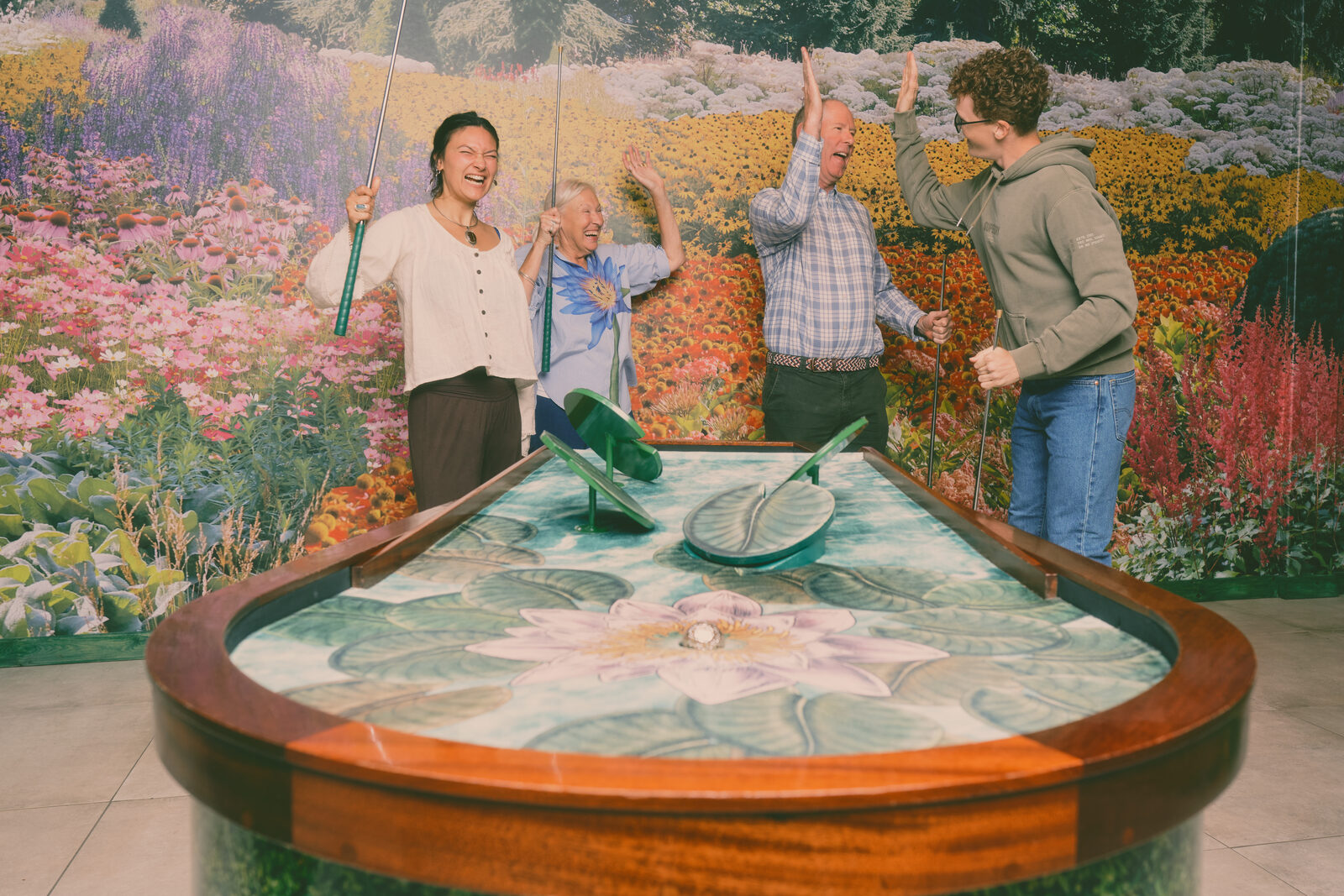 Four generations around a Cue Golf table at the Flower Bowl